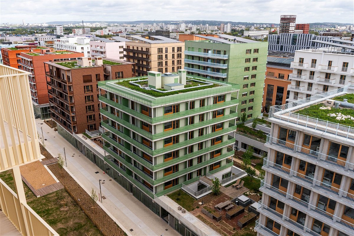 <i>Nathan Laine/Bloomberg/Getty Images via CNN Newsource</i><br/>Solar panels and green roofs on the top of athletes' accommodation in the Olympic Village in Saint-Denis