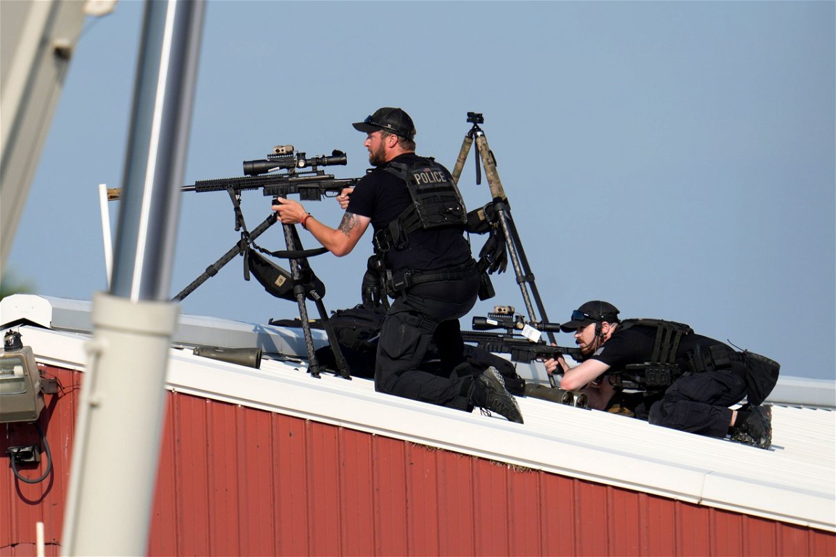 <i>Gene J. Puskar/AP via CNN Newsource</i><br/>Law enforcement snipers return fire after shots were fired while former President Donald Trump was speaking at his rally.