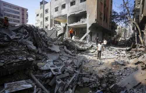 Civil defense teams and locals investigate the rubble after the Israeli operation in Nuseirat camp