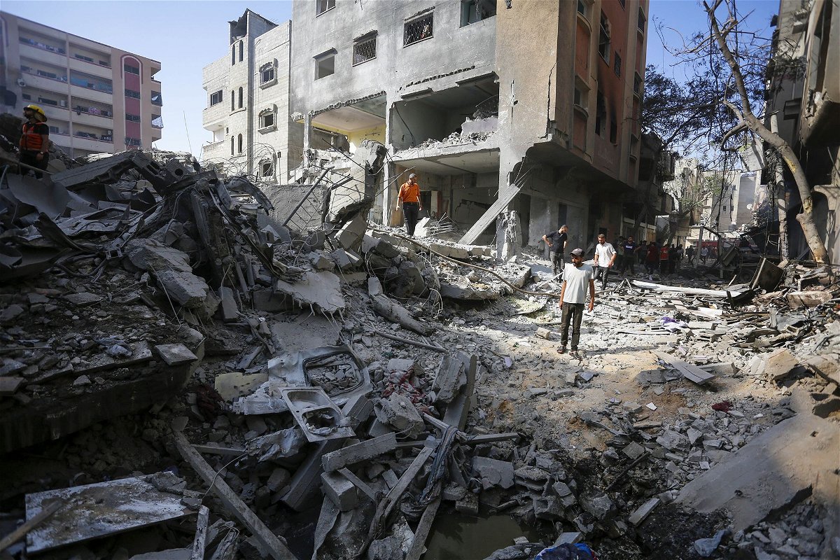 <i>Ashraf Amra/Anadolu/Getty Images via CNN Newsource</i><br/>Civil defense teams and locals investigate the rubble after the Israeli operation in Nuseirat camp