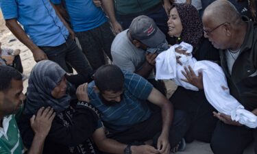 A Palestinian mother holds the body of her baby girl