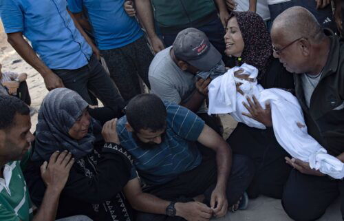 A Palestinian mother holds the body of her baby girl