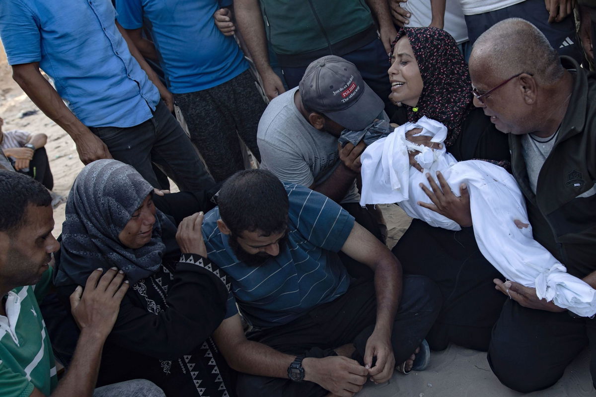 <i>Haitham Imad/EPA-EFE/Shutterstock via CNN Newsource</i><br/>A Palestinian mother holds the body of her baby girl