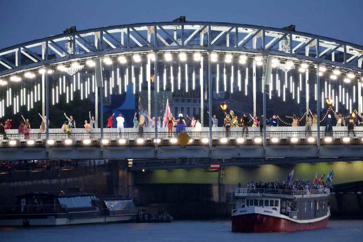 <i>Wally Skalij/Los Angeles Times/Getty Images via CNN Newsource</i><br/>Performers are seen on a catwalk erected along the Passerelle Debilly bridge in Paris during the opening ceremony.