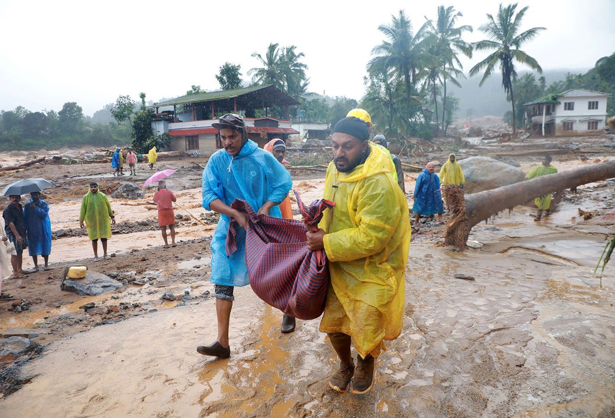 <i>Stringer/Reuters via CNN Newsource</i><br/>Rescuers carry the body of a victim at a landslide site in Wayanad