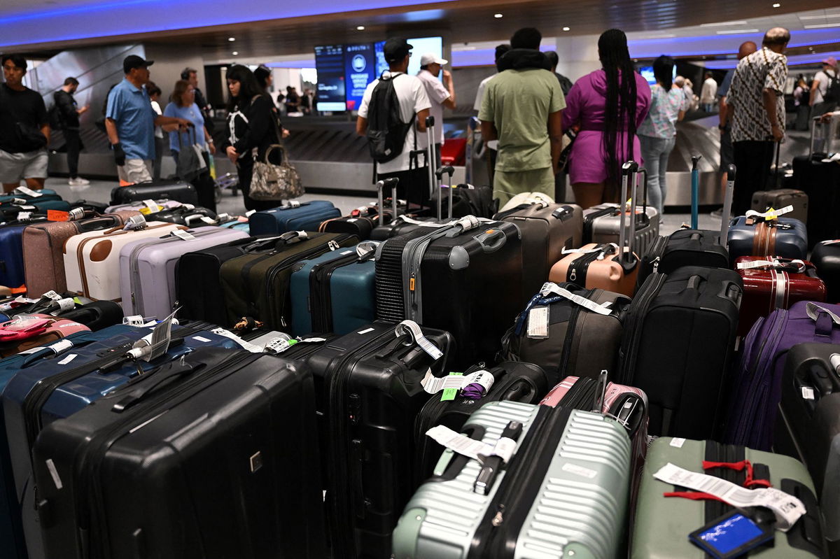 <i>Patrick T. Fallon/AFP/Getty Images via CNN Newsource</i><br/>Bags await reunification with their owners in the Delta Air Lines baggage claim area Los Angeles International Airport on July 24