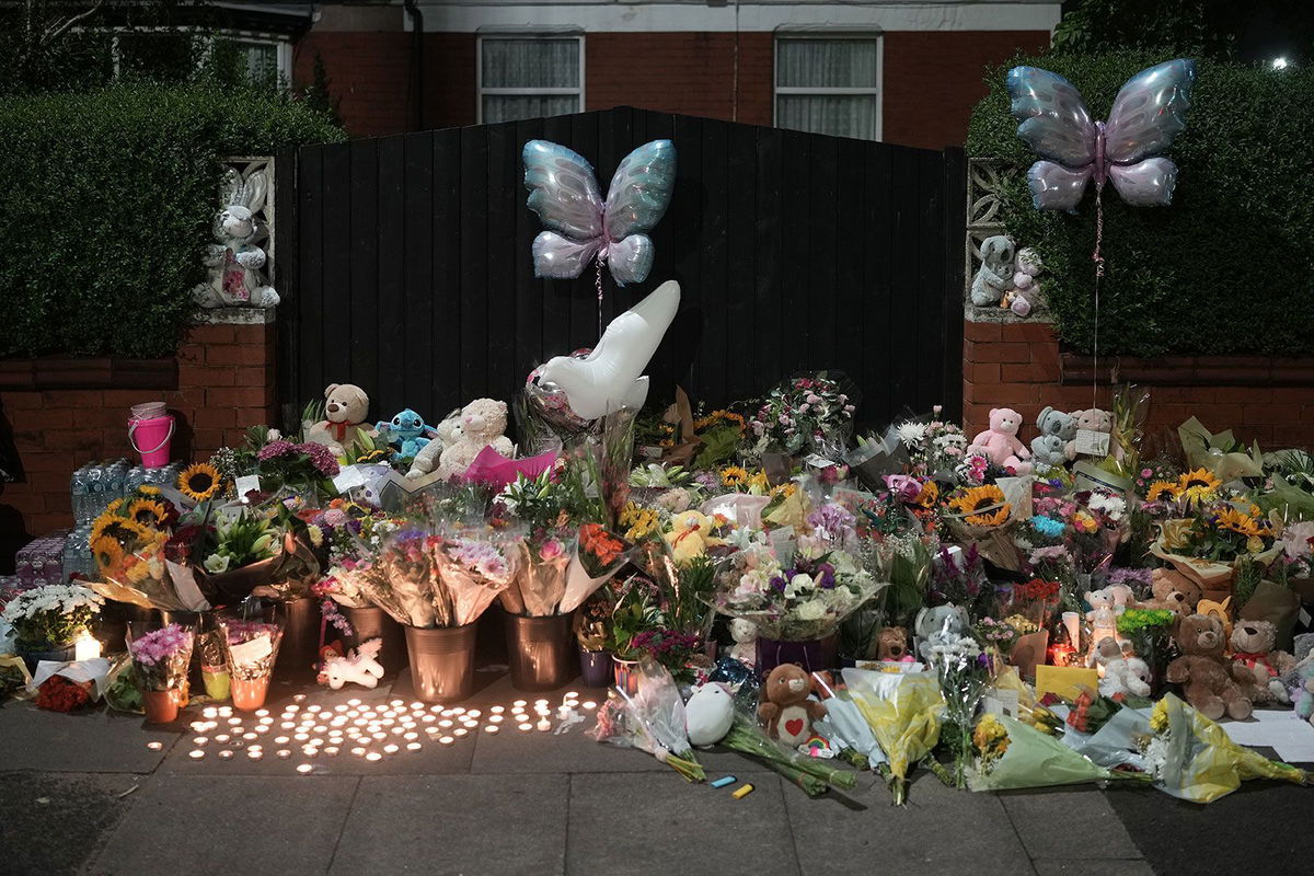 <i>Christopher Furlong/Getty Images via CNN Newsource</i><br/>Tributes and candles to the victims of the Southport knife attack laid near the scene on July 30