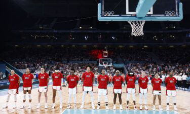 Team USA players stand during Japan's national anthem before their group match at the Paris 2024 Olympic Games.