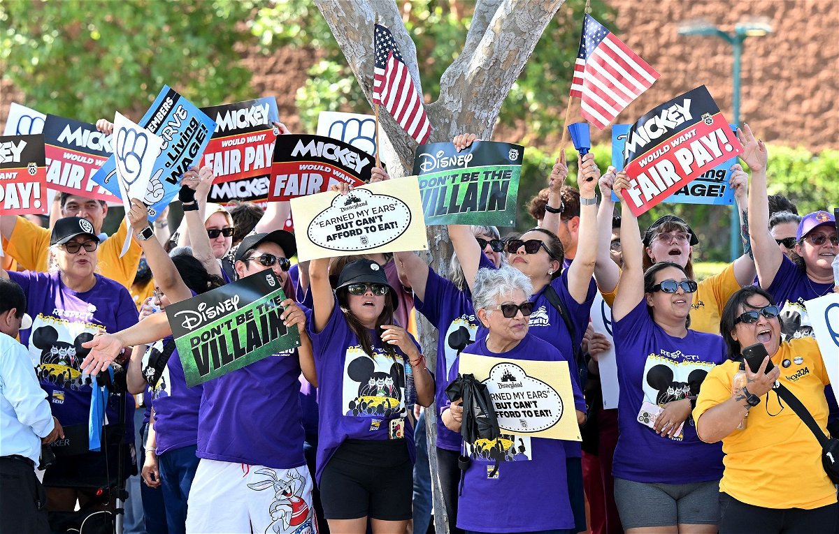 <i>Frederic J. Brown/AFP/Getty Images via CNN Newsource</i><br/>Disney employees rally outside the main entrance of Disneyland Resort in Anaheim
