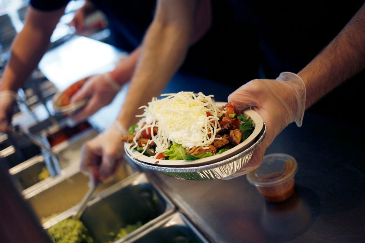 <i>Luke Sharrett/Bloomberg/Getty Images/File via CNN Newsource</i><br/>An employee prepares a burrito bowl at a Chipotle Mexican Grill Inc. restaurant in Louisville