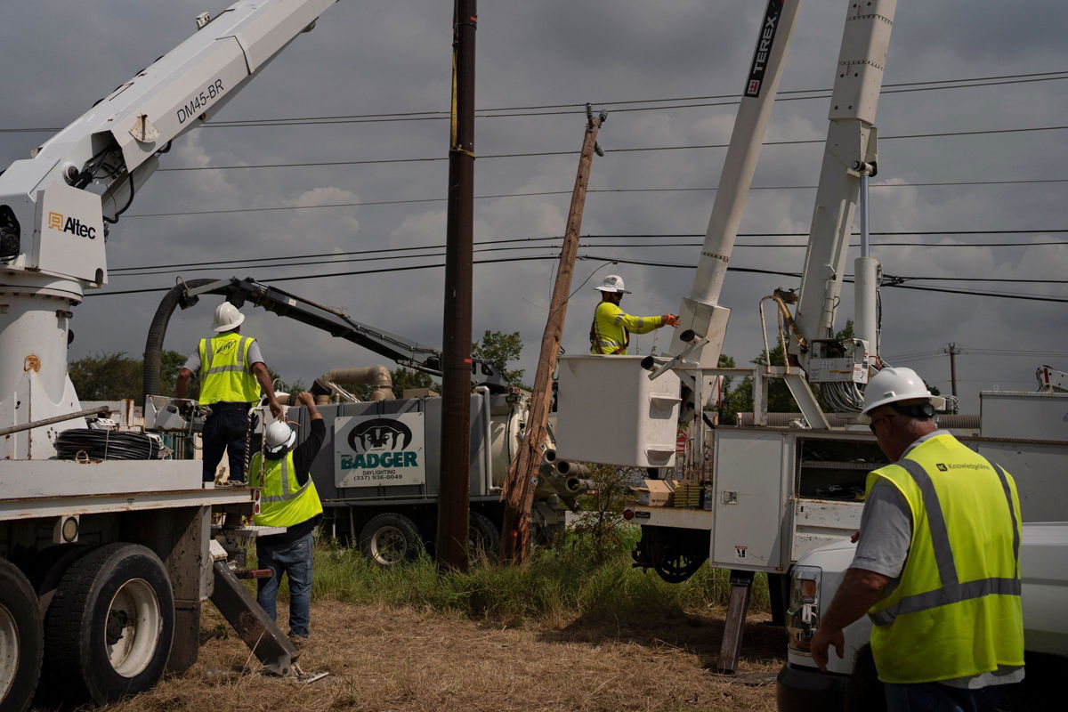 <i>Danielle Villasana/Getty Images via CNN Newsource</i><br/>CenterPoint foreign assistance crews work to restore power lines on July 11 in Houston