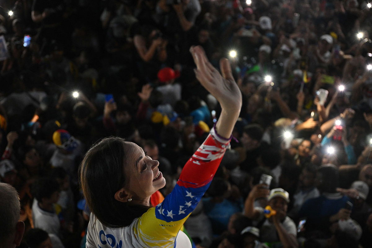 <i>Federico Parra/AFP/Getty Images via CNN Newsource</i><br/>Venezuelan opposition leader Maria Corina Machado waves during the campaign closing rally of presidential candidate Edmundo Gonzalez Urrutia in Caracas on July 25