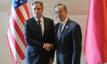 US Secretary of State Antony Blinken shakes hands with Chinese counterpart Wang Yi on the sideline of the ASEAN foreign ministers' meeting in Vientiane