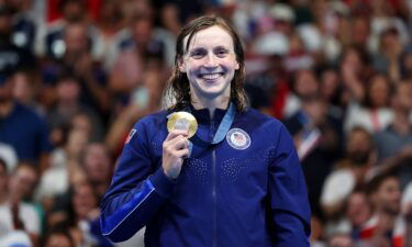 Ledecky poses with her first gold of these Games.