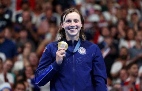 Ledecky poses with her first gold of these Games.