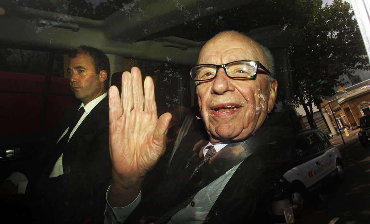 <i>Lewis Whyld/PA Images/Getty Images via CNN Newsource</i><br/>Rupert Murdoch leaves News International headquarters with then-News International Group General Manager Will Lewis in 2011.