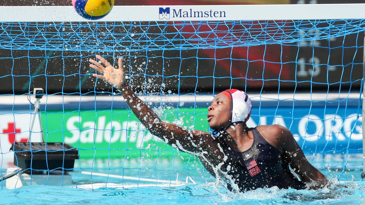 Water polo goalkeeper makes a save.