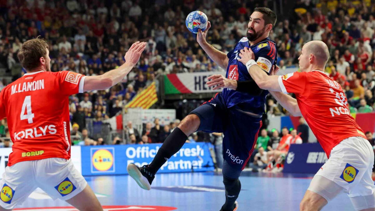 Handball player prepares to shoot the ball at goal.