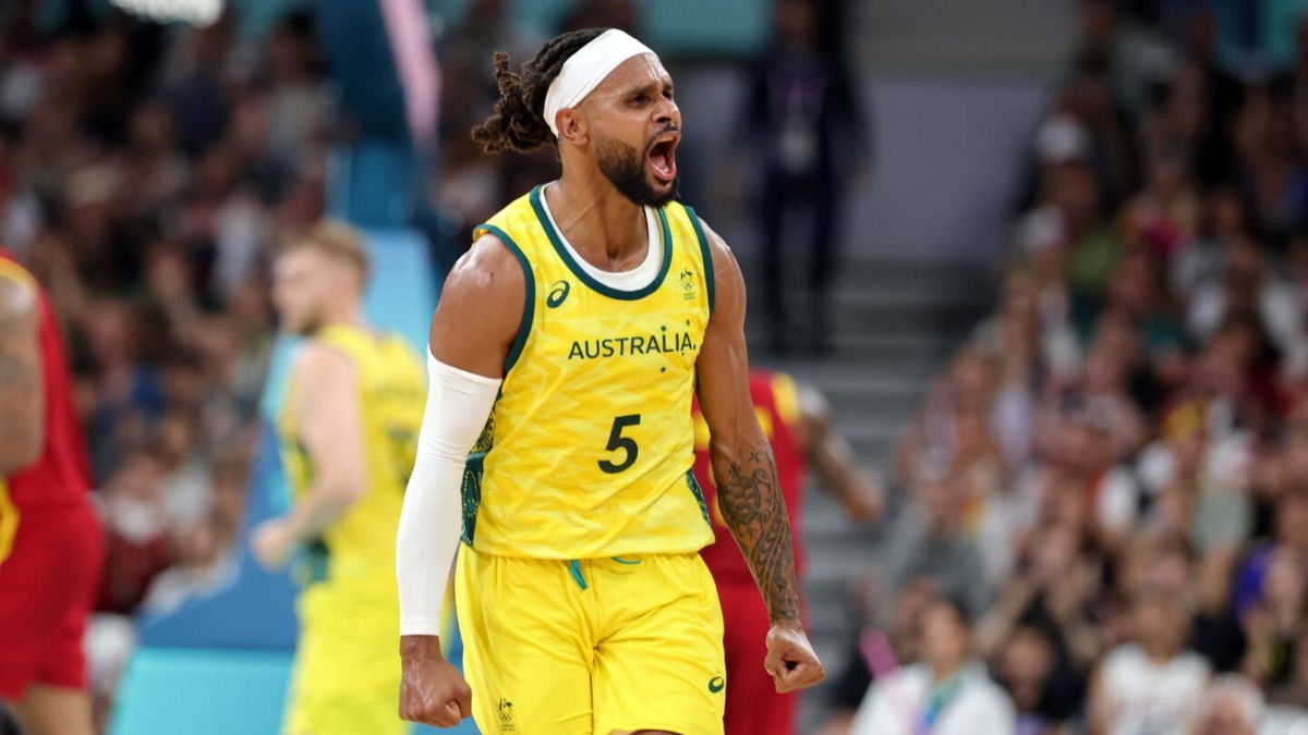 Patty Mills celebrates during Australia's win over Spain