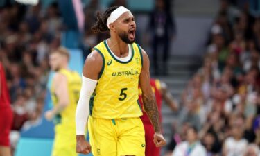 Patty Mills celebrates during Australia's win over Spain