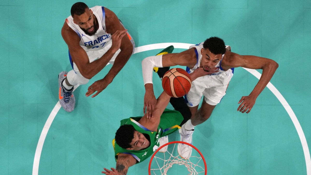 Victor Wembanyama and Rudy Gobert contest a shot at the rim against Brazil