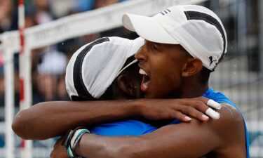 Cuba's Noslen Diaz and Jorge Alayo embrace during their Pool D match against the United States