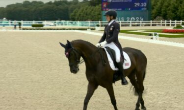 Liz Halliday-Sharp rides her horse in the eventing competition.