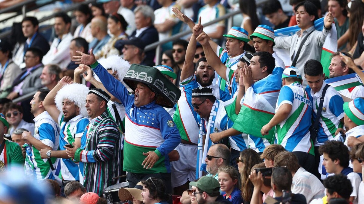 Uzbekistan fans celebrate country's first ever goal at a major tournament.