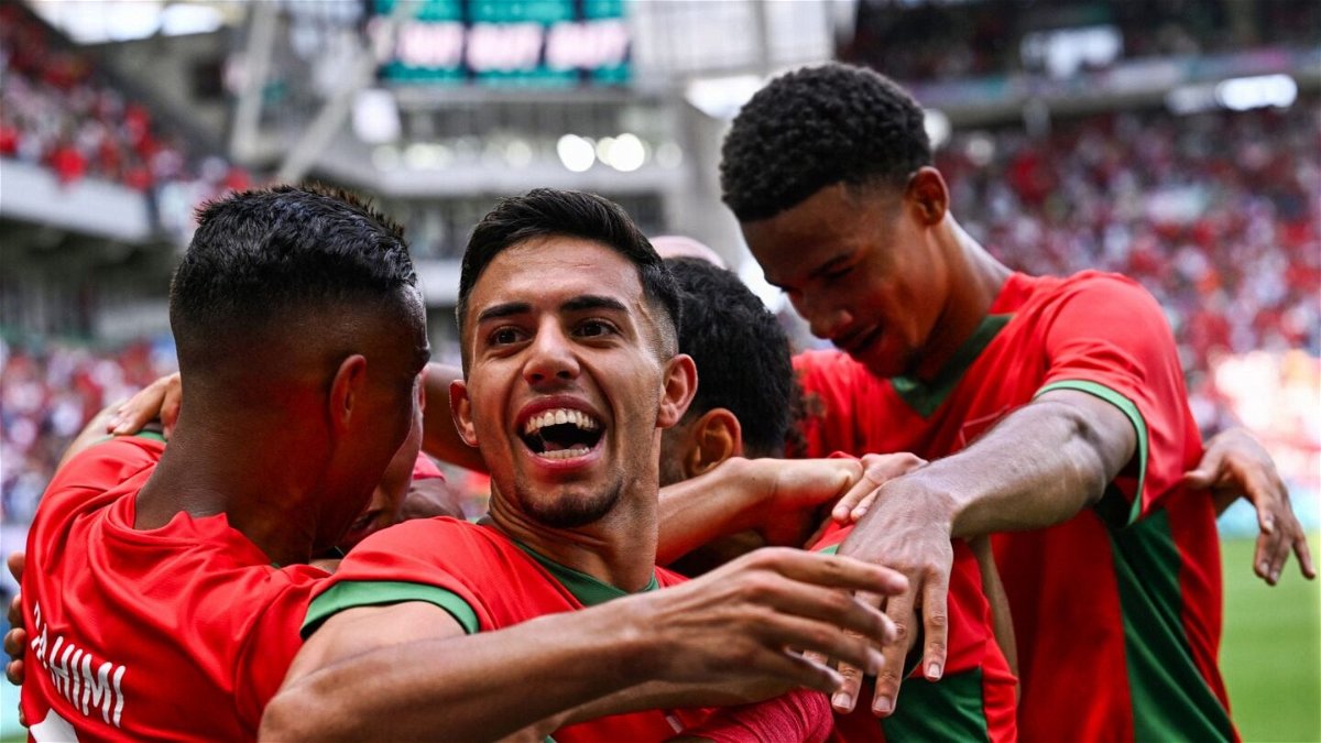Morocco players celebrate after scoring an Olympic goal.