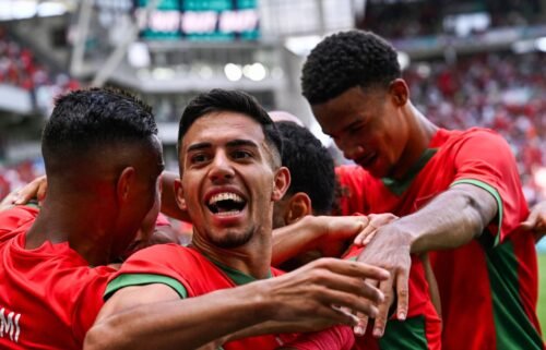 Morocco players celebrate after scoring an Olympic goal.