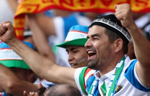 An Uzbekistan fan celebrates a tremendous save from the penalty spot to keep the game level.