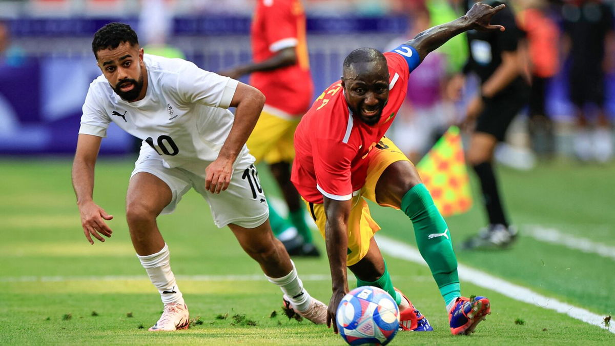 Guinea player dribbles with the ball.