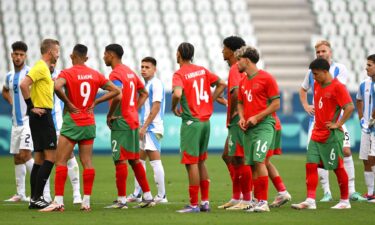 Morocco players stand on the pitch