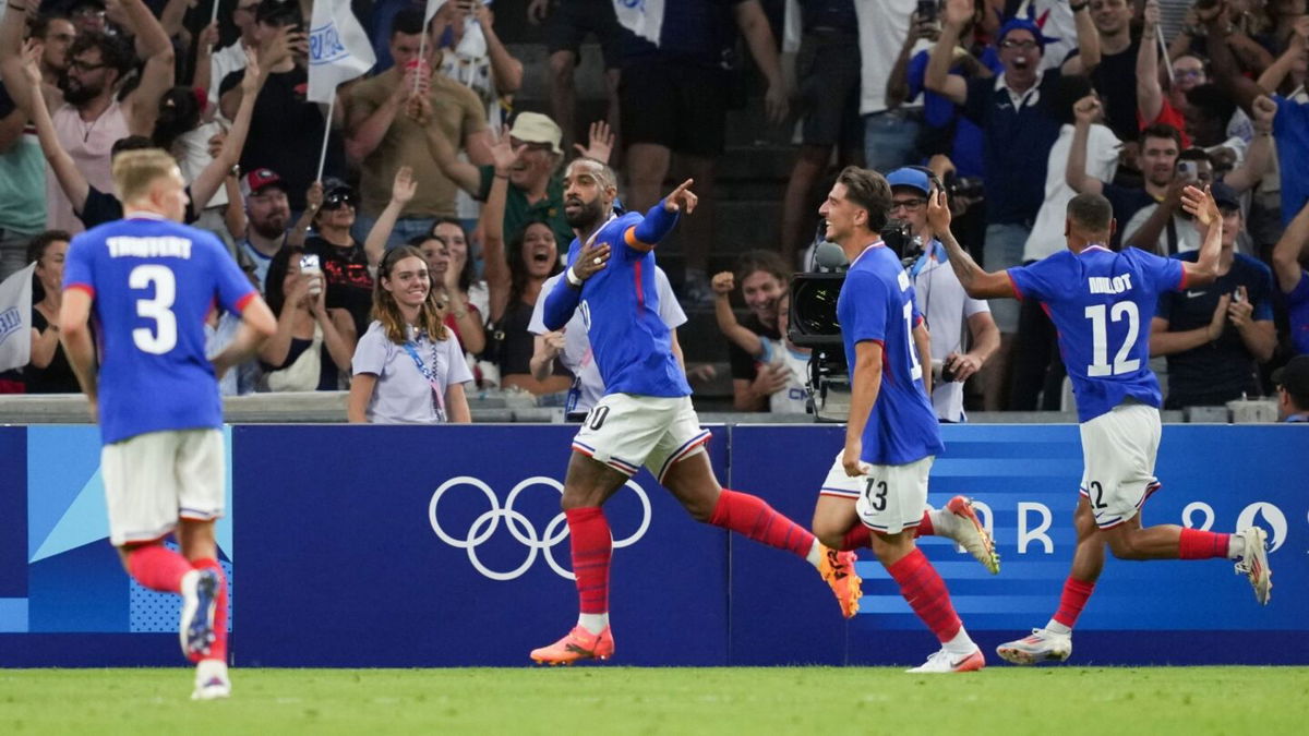 France players celebrate after scoring a goal.