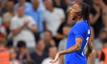 Michael Olise celebrates after scoring a goal.