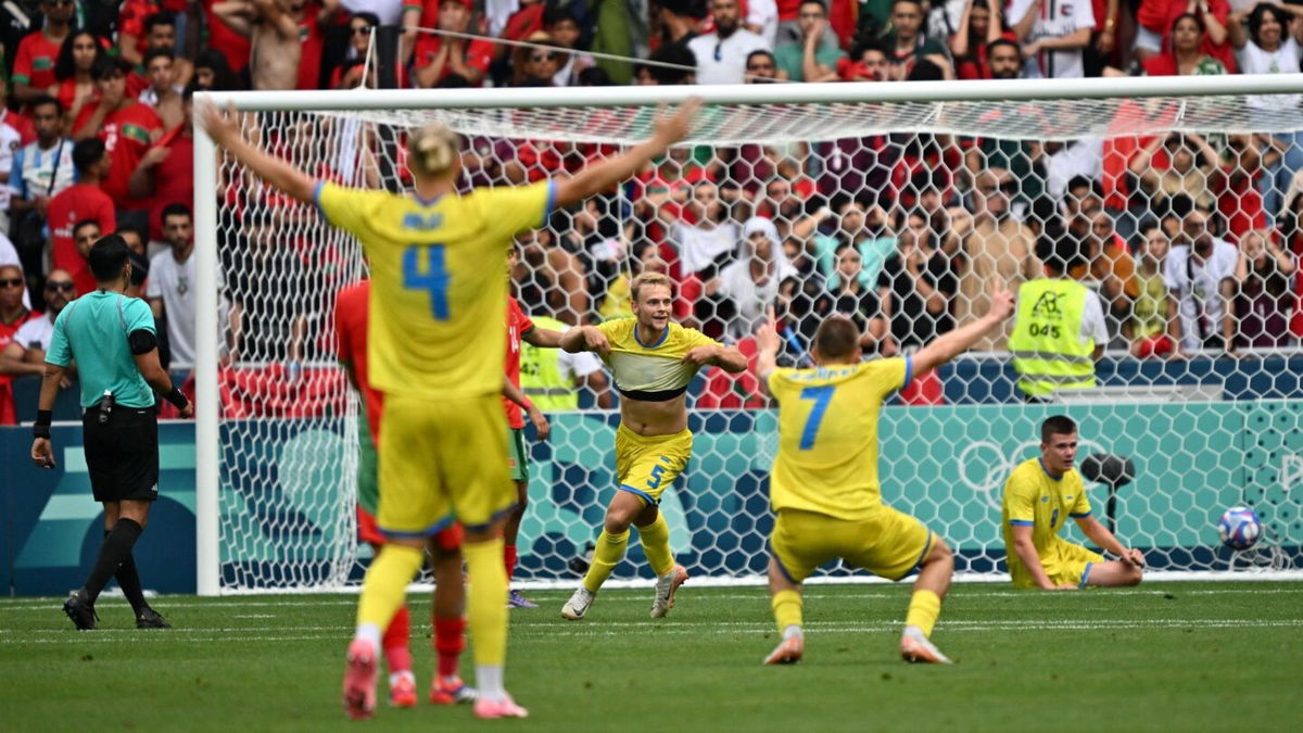 Ukraine players celebrate after scoring a goal.