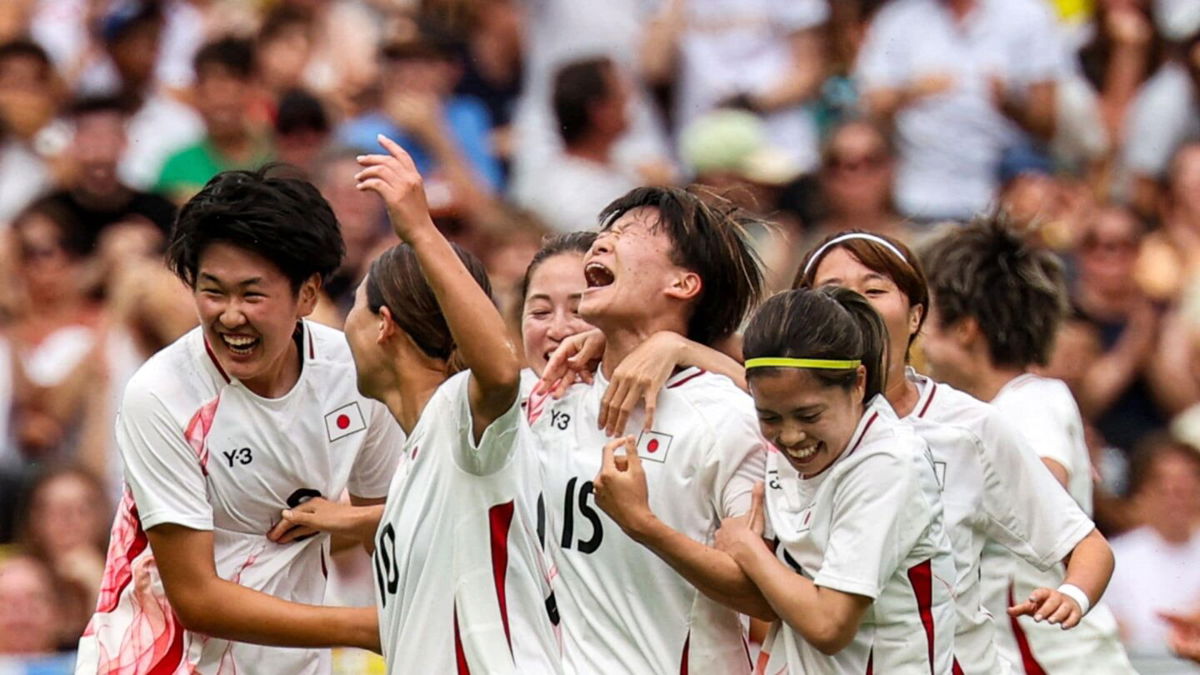 Japan players celebrate after scoring a goal
