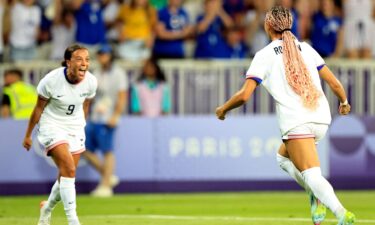 USWNT players celebrate after scoring a goal.