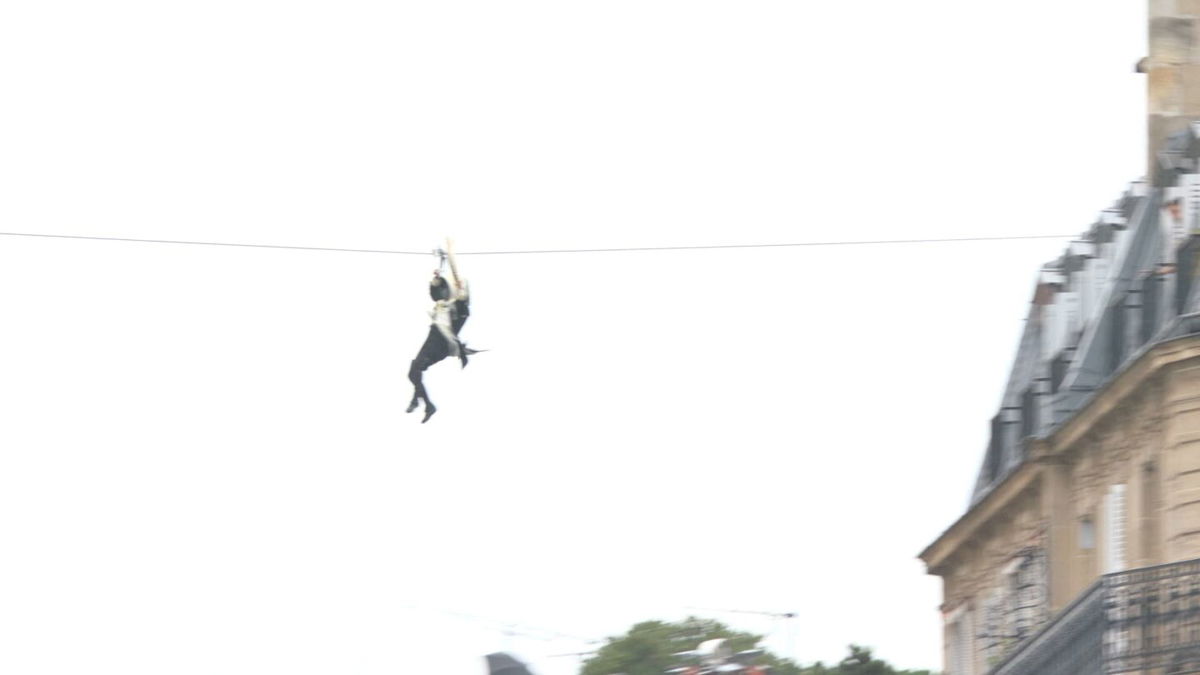 Olympic torch ziplines over River Seine