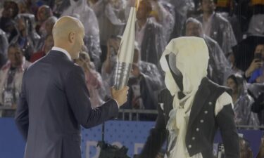 Zinedine Zidane takes the Olympic torch