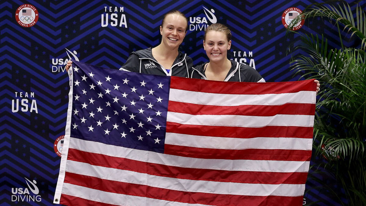 Krysta Palmer and Alison Gibson hold an American flag