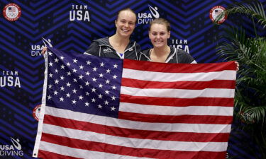 Krysta Palmer and Alison Gibson hold an American flag