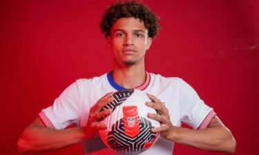 Kevin Paredes poses while holding a soccer ball