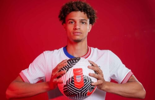 Kevin Paredes poses while holding a soccer ball