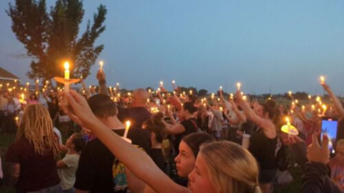 <i>KSL via CNN Newsource</i><br/>People hold candles at the vigil held for Gavin Peterson