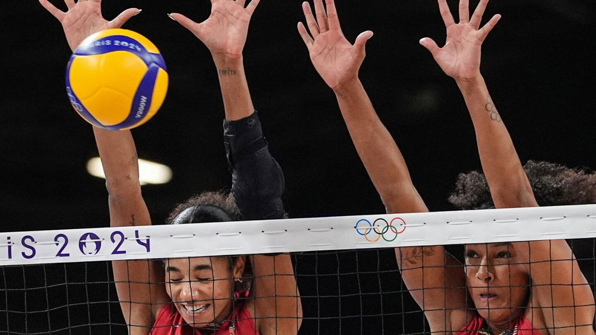 Team USA's Jordan Thompson and Haleigh Washington block the ball during the women's preliminary round volleyball match between USA and Serbia during the Paris 2024 Olympic Games at the South Paris Arena 1.