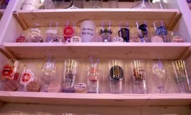 Hundreds of drinking glasses from pints to snifters to tasters are strategically placed on shelves lining the walls by Michael Smith's personal bar.