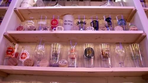 <i>WDJT via CNN Newsource</i><br/>Hundreds of drinking glasses from pints to snifters to tasters are strategically placed on shelves lining the walls by Michael Smith's personal bar.