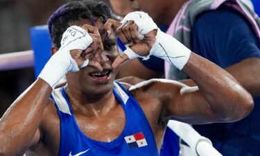 Panama's boxer Bylon makes a heart shape with her fingers