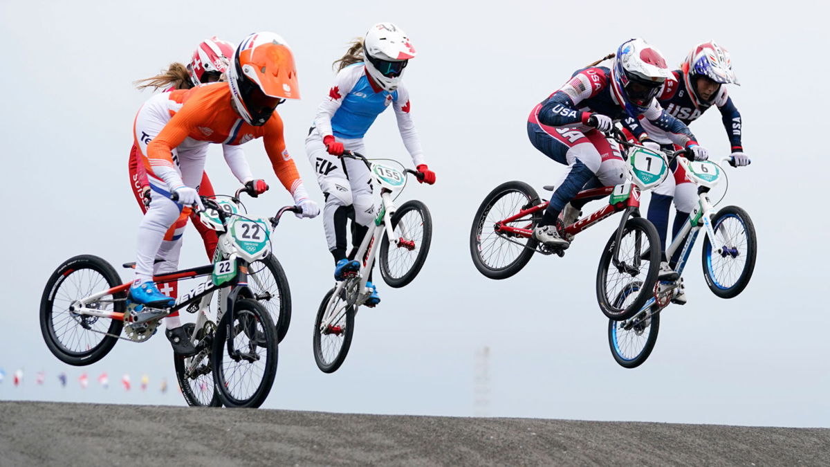Multiple riders in the air during a BMX race